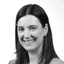 Black and white headshot of a smiling woman with dark hair looking forward.