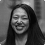 Smiling Asian woman with long dark hair, looking directly at the viewer.