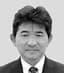 Black and white headshot of an Asian man in a suit and tie.